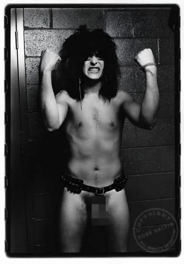 Nikki Sixx of Motley Crue naked except for an ammunition belt. Photo by Ross Halfin
